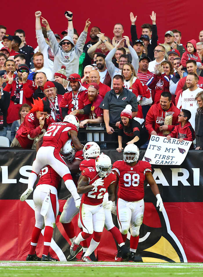Cardinals players celebrate with defensive tackle Calais Campbell (93) after returning a fumble for a touchdown in the second quarter against the Saints at University of Phoenix Stadium.